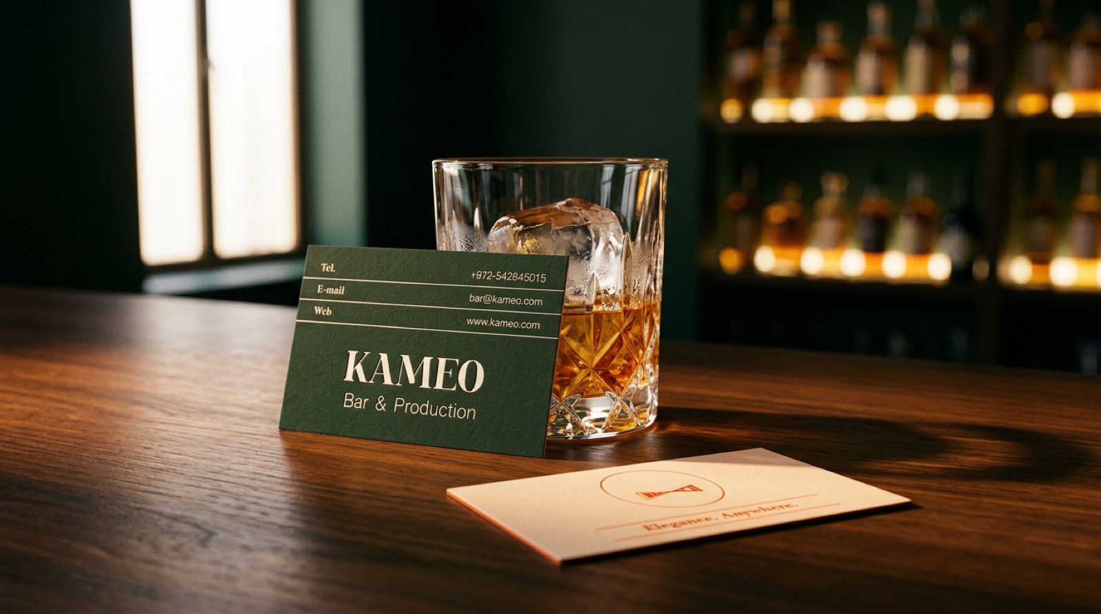 Kameo — green primary and cream secondary business cards on a wooden bar